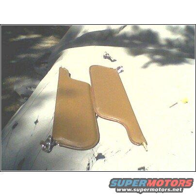 Two tan car sun visors with metal mounting hardware