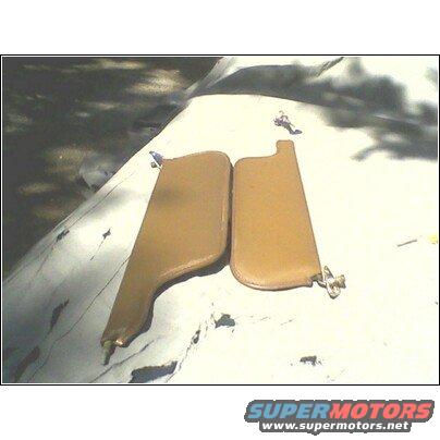 two tan car sun visors on a white surface