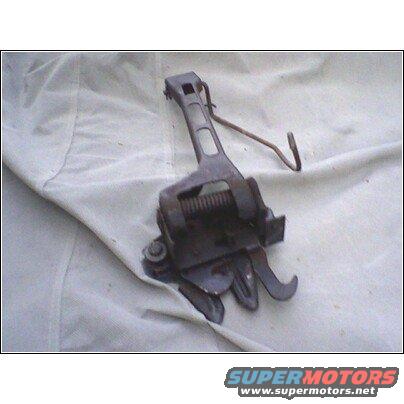 Hood latch mechanism on a white cloth background