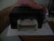 1994 Ford Bronco - A hand holds a black electronic module with a white connector attached.