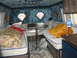 1978 Ford E250 - The interior of a van conversion shows plush seating and decorative diamond windows.