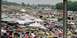 1976 Ford Ranchero - A wide view of a car show with numerous vehicles and tents spread across a grassy field.