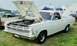 1976 Ford Ranchero - White 1966 Ford Fairlane Ranchero on display with its hood open, next to another vehicle.