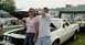 1976 Ford Ranchero - Couple poses with a white 1976 Ford Ranchero at an outdoor car show.