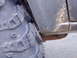 1989 Ford F-250 - A close-up view shows a large off-road tire positioned near the fender and leaf spring of a vehicle.