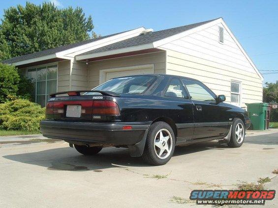 Black 1989 Mazda MX-6 rear 3/4 view