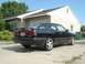1989 Mazda MX-6 - A black 1989 Mazda MX-6 is parked in a driveway in front of a house.