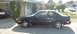 1989 Mazda MX-6 - Side view of a black 1989 Mazda MX-6 coupe parked in a suburban driveway.