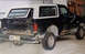 1988 Ford Bronco - This 1988 Ford Bronco shows significant rust damage on its body panels and rear tailgate.