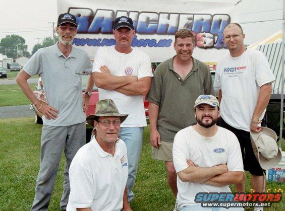 Six men pose in front of a banner that says "RANCHERO"