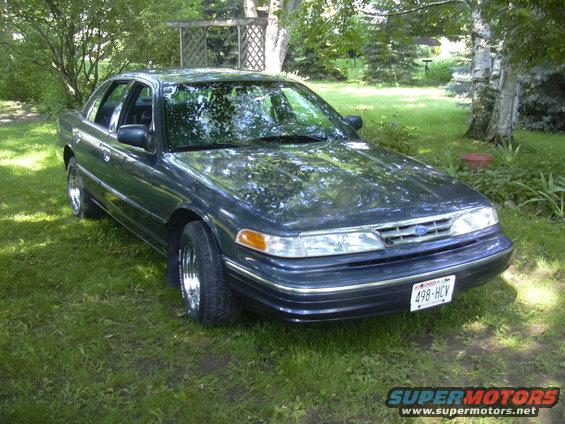 1996 Ford Crown Victoria parked on grass, front 3/4 view. License plate 498-HCV