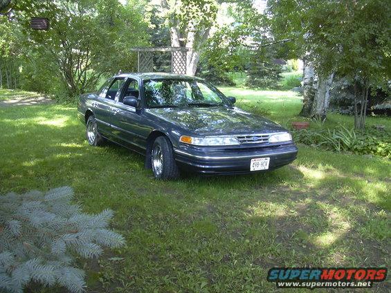 1996 Ford Crown Victoria parked on lawn, front 3/4 view. License plate reads 498-HCV