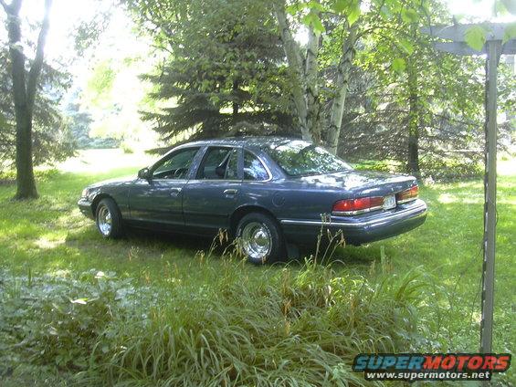 Dark blue 1996 Ford Crown Victoria parked in a grassy yard