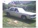 1991 Ford Crown Victoria - This 1980s Ford sedan is parked on a grassy area with trees and houses in the background.