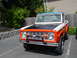 1973 Ford Bronco - Front view of a two-tone 1973 Ford Bronco with an orange grille surround and black hood.