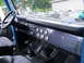1973 Ford Bronco - The interior of a 1973 Ford Bronco, a custom dashboard with multiple gauges and a prominent gear shifter.