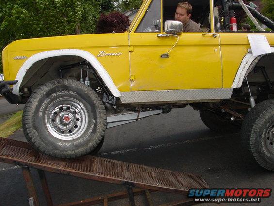 Yellow 1973 Ford Bronco side view on ramp