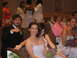 1988 Ford Bronco - Guests attend a wedding ceremony, seated in pews with floral arrangements.