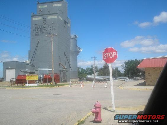 Scene of storm damage with a grain elevator and stop sign