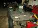 1999 Honda RANCHER - A green Polaris ATV is parked indoors next to a black truck and toolboxes.