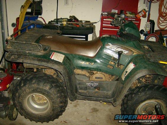 Green Polaris Xplorer ATV, side view. Visible text: 4x4, Concentric Drive System