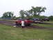 1994 Ford F-250 - Several trucks participate in a mud drags event on a muddy track.
