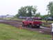 1994 Ford F-250 - Pickup truck competes in a mud drag race event with other vehicles present.