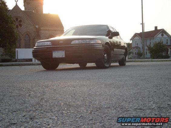1992 Ford Crown Victoria parked on asphalt with a church and houses in the background