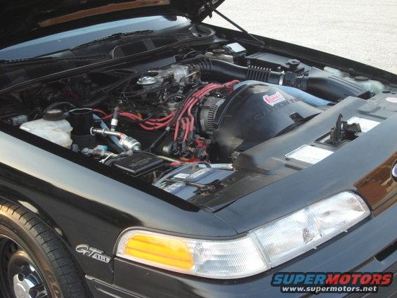 Engine bay of a 1992 Ford Crown Victoria, showing the V8 engine, battery, and air intake