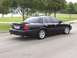 2001 Ford Crown Victoria - This black 2001 Ford Crown Victoria sedan is shown from the rear three-quarter angle.