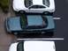 1996 Ford Crown Victoria - A dark green 1996 Ford Crown Victoria sedan is parked next to a white sedan and a white van.