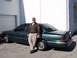 1996 Ford Crown Victoria - A man poses with a green sedan. The vehicle appears to be from the mid-1990s.