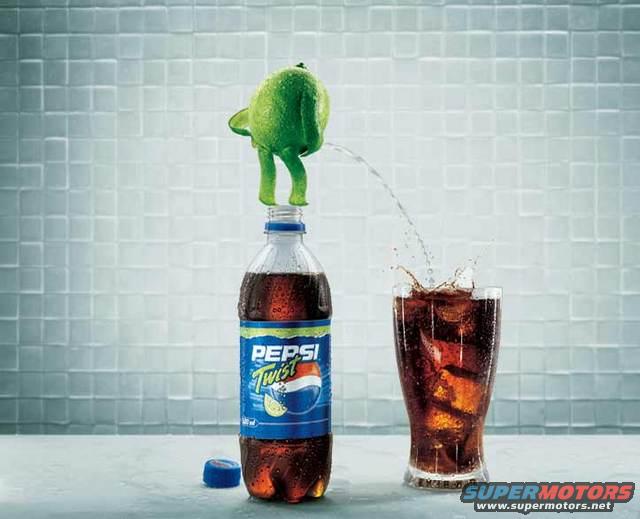 Pepsi Twist bottle with a lime on top, pouring liquid into a glass of cola
