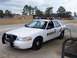 2003 Ford Crown Victoria - A Wayne County Sheriff's patrol car is seen refueling at a gas station.