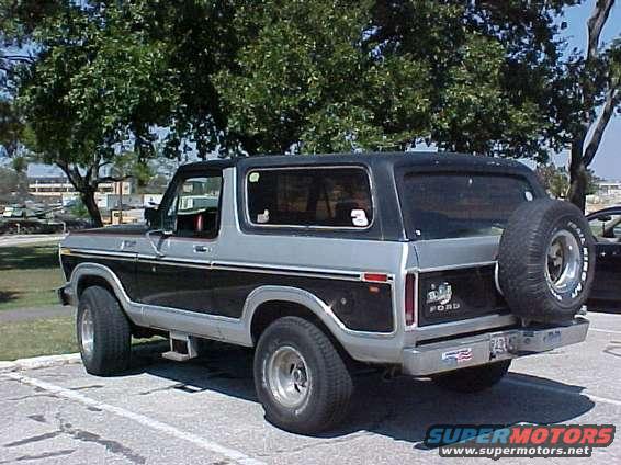 Two-tone black and silver Ford Bronco parked outside with a spare tire on the back