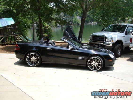 Black 2004 Mercedes-Benz SL-Class convertible with butterfly doors