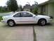 1995 Ford Thunderbird - Side view of a white coupe with a red pinstripe detail.