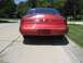 1996 Lincoln Mark VIII - Rear view of a red 1996 Lincoln Mark VIII parked on a driveway.