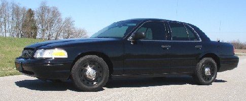 Black 2003 Ford Crown Victoria sedan, side view
