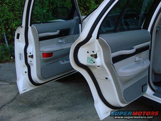 Front and rear passenger doors open showing gray door panels with red reflectors and black trim