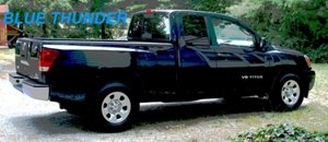 Blue Nissan Titan pickup truck parked outside