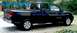 2007 Nissan Titan - A dark blue 2007 Nissan Titan pickup truck is parked outdoors, showing its side and front quarter view.