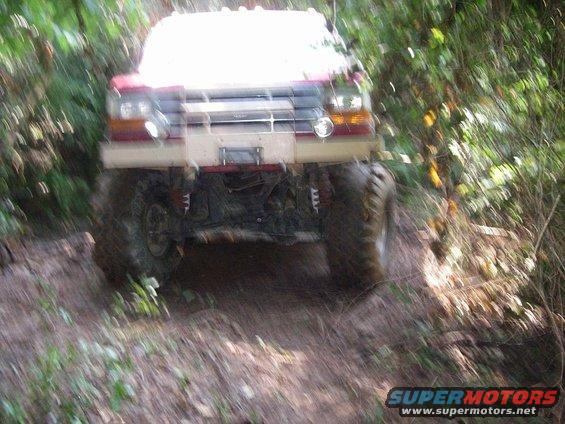 1995 Ford Bronco driving off-road, front view