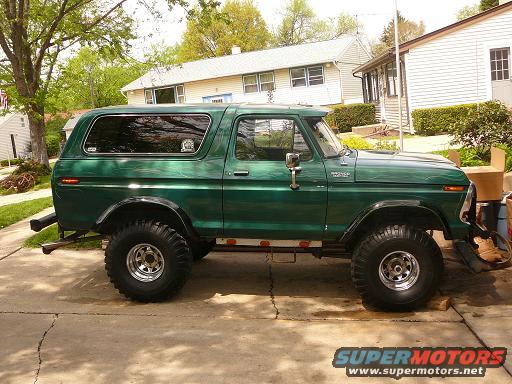 Green 1978 Ford Bronco side view, lifted with large tires