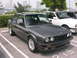 1989 BMW 3 Series - A dark gray 1989 BMW 3 Series coupe is parked in a lot with another BMW visible.
