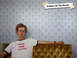 1970 Mercury Cougar - Man with glasses and a "Vote for Calisa" t-shirt sits on a tufted couch.