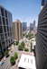 1996 Ford Bronco - A view from above shows a busy city street with cars and pedestrians amidst urban architecture.