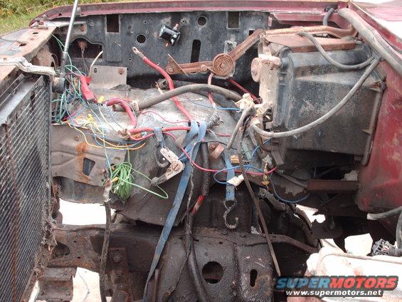 Engine bay with exposed wiring and components