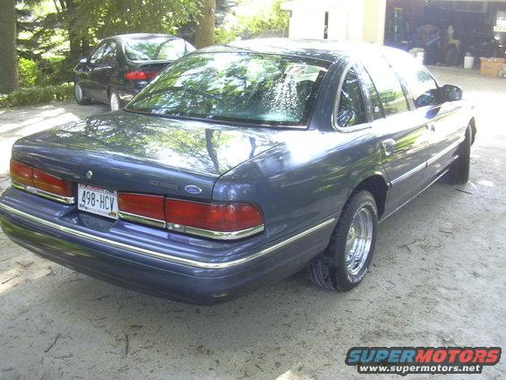 1996 Ford Crown Victoria parked on gravel, another car behind it