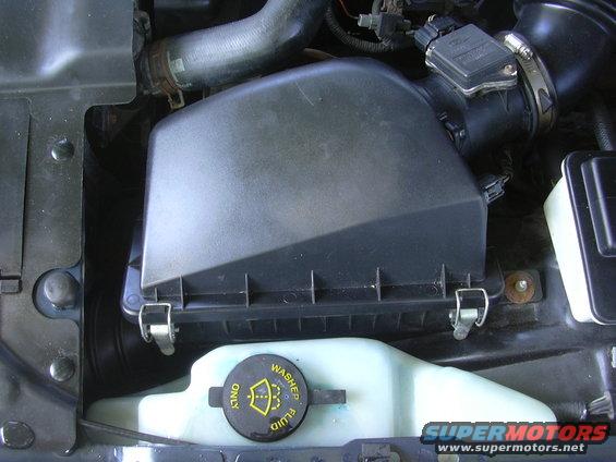 Engine bay air filter housing and washer fluid reservoir